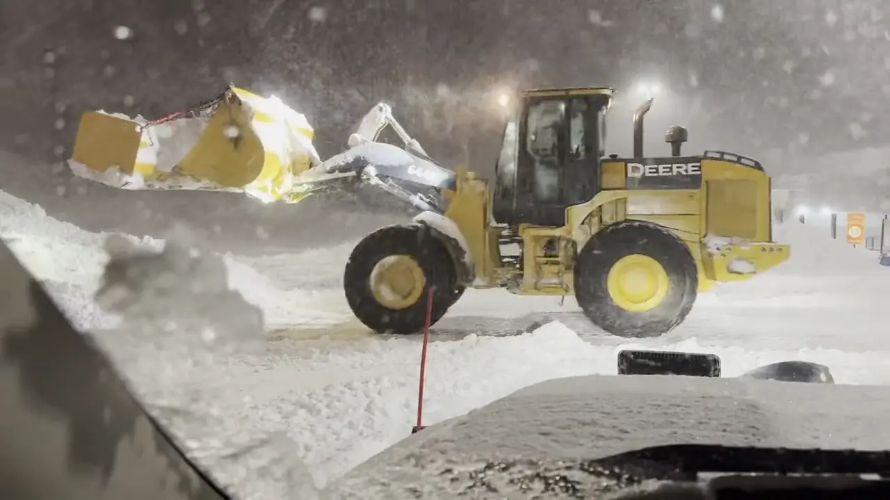 Wheel loader pushing snow in a heavy night snowstorm